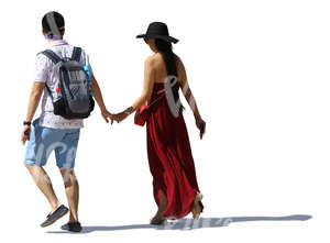 asian couple walking hand in hand in summertime