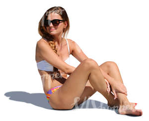 woman in a bikini sitting and looking around
