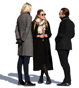 group of three young people standing and talking