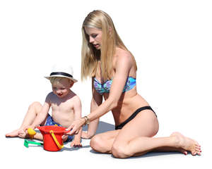 woman playing with her son on the beach