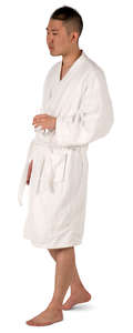 asian man in a bathrobe walking