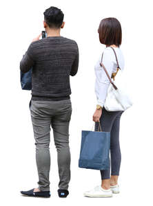 asian couple with shopping bags standing
