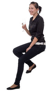 young woman sitting at a bar and drinking champagne