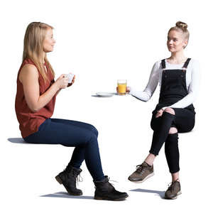 two young women sitting in a cafe