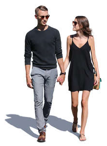 couple walking hand in hand on a sunny day