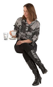 woman sitting in a cafe and drinking coffee