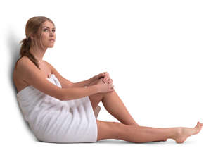 woman in a wrapped towel sitting in a sauna