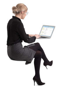 woman sitting at an office table and working