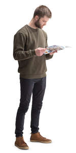 man standing and reading a magazine