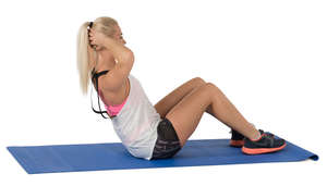 woman doing exercises on a yoga mat