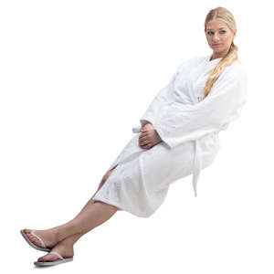 woman in a white bathrobe sitting