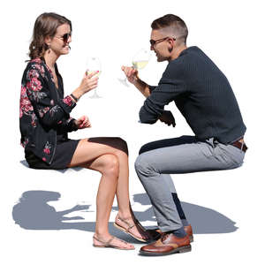 couple sitting in a cafe on a sunny day and drinking wine