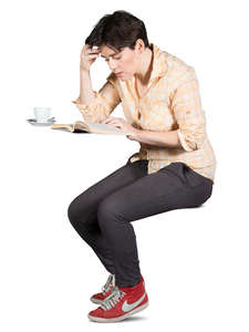 woman sitting in a cafe and reading a book