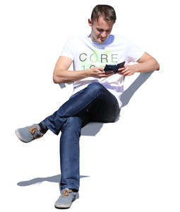 man sitting and checking his phone