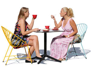 two women sitting in a cafe and eating cake