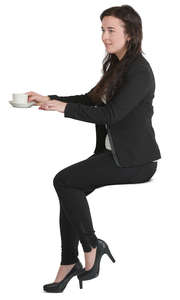 woman sitting at a counter and drinking coffee