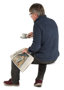 man sitting in a cafe and drinking coffee