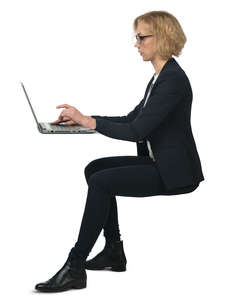 businesswoman sitting behind the desk and working on a computer