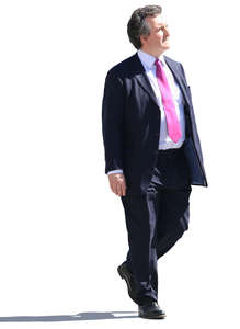 older businessman walking on a sunny day