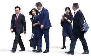group of asian businessmen and businesswomen walking