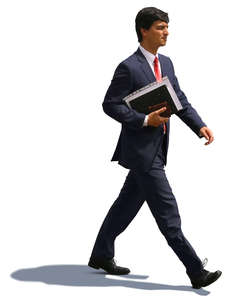 businessman with notebook under his arm walking hastily