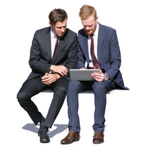 two businessmen sitting and looking at a tablet
