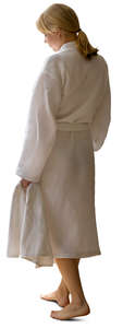 woman in a white bathrobe walking