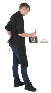 man standing in a kitchen and cooking