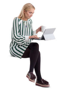 woman in a striped dress sitting behind a desk