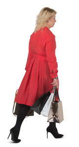 woman in a red dress carrying shopping bags walking