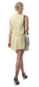 woman in a yellow summer dress walking