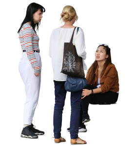 three women standing and talking