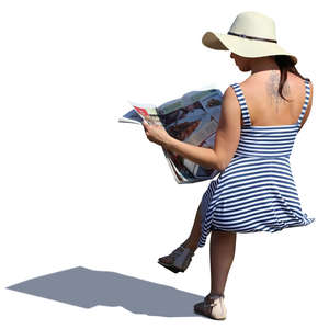 woman in a summer dress sitting and reading a newspaper