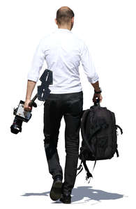 man walking and carrying camera equipment