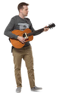 man standing and plying a guitar