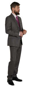 man in a grey suit standing and looking
