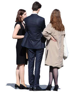 group of three people in formal clothing standing and talking