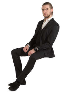 man in a black suit sitting