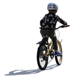 little backlit boy riding a bike