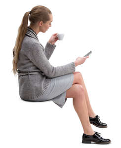 woman sitting and drinking coffee