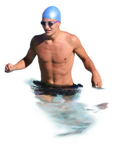 man with a swim cap and goggles standing in water