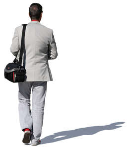 man with a camera bag walking