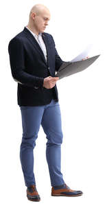 businessman standing and looking at papers
