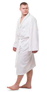 man in a white bathrobe walking