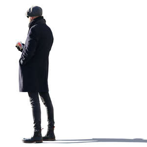 backlit man with a coffee standing