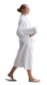 woman in a white bathrobe walking