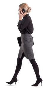 businesswoman walking and talking on a phone