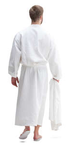 man in a bathrobe walking seen from back