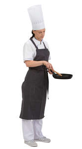 female chef standing with a frying pan