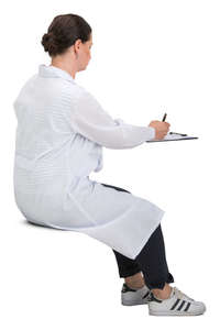 female doctor sitting and writing
